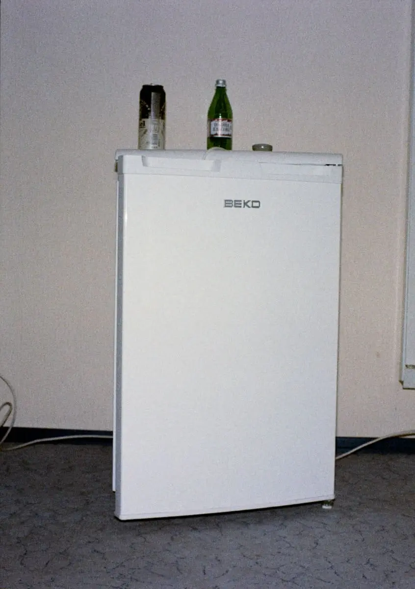 White refrigerator with drinks on top