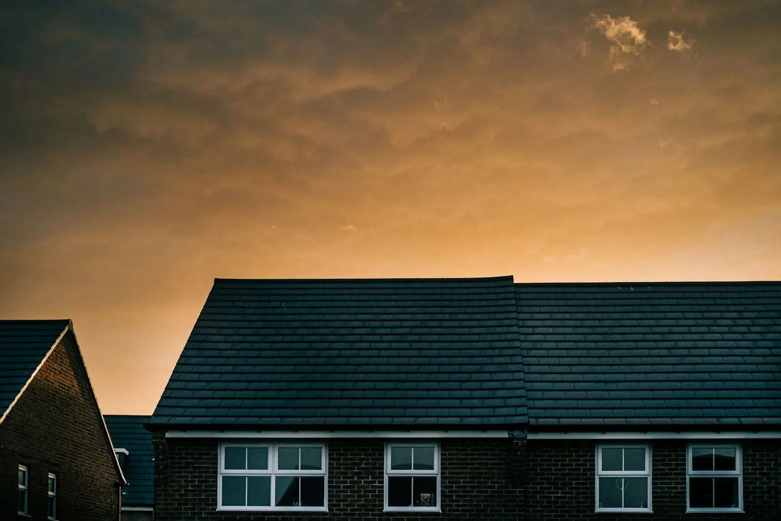 Photo by Peter Mason white and black house under gray sky
