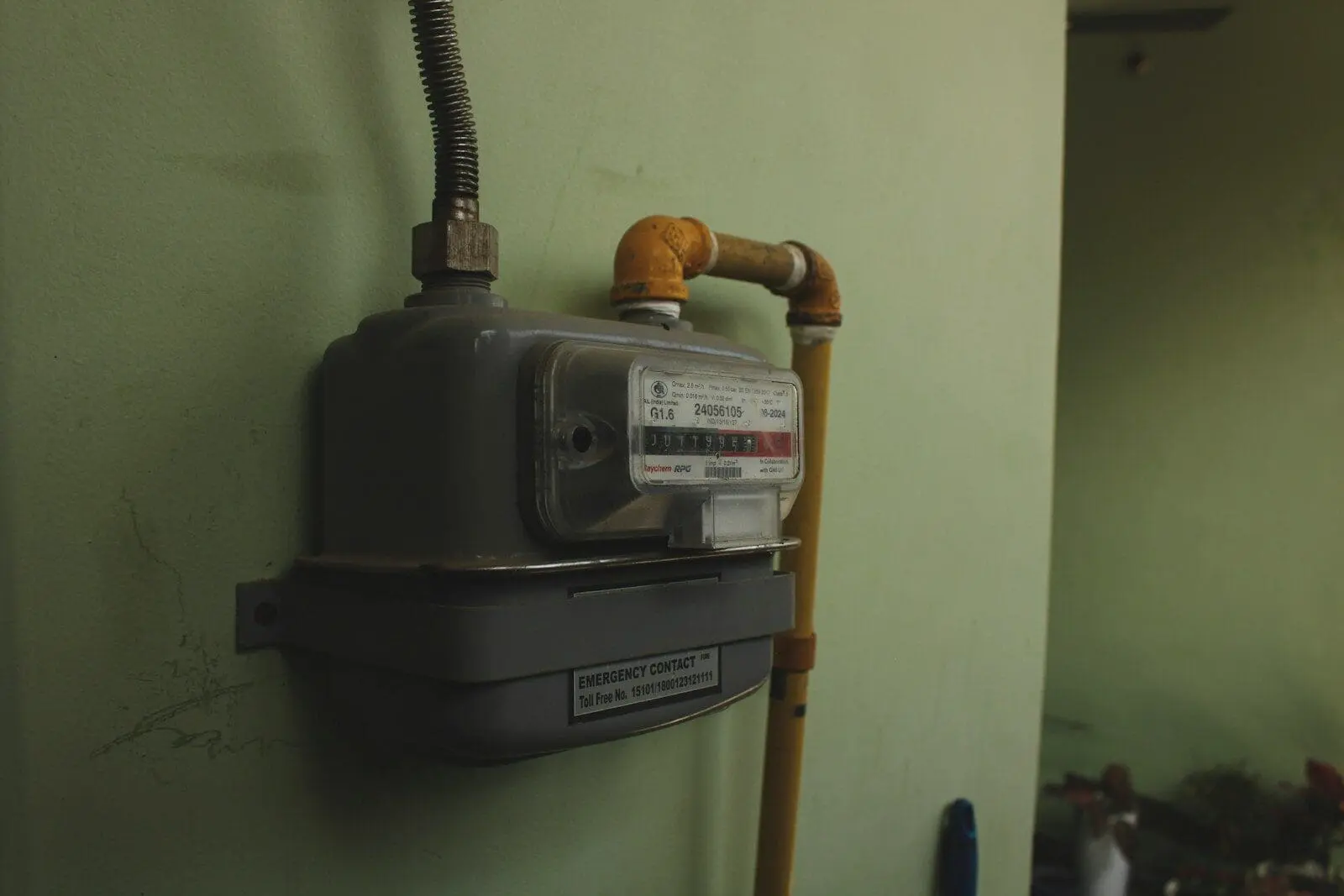 Photo by Parth Mishra A gas meter mounted on a pale green wall.