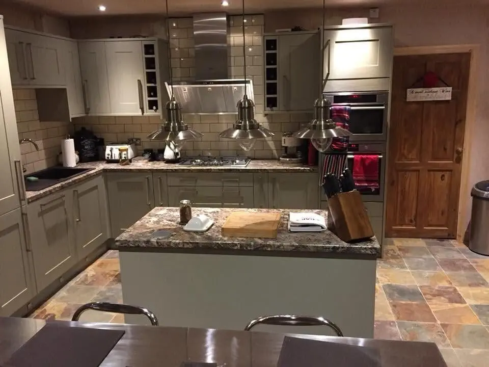 Sage green shaker kitchen with island and granite worktops in Sheffield by Heat365