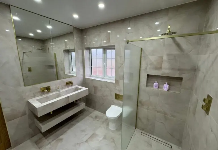 Bathroom fitted by Heat365 in Sheffield with a twin basin vanity and brushed brass taps