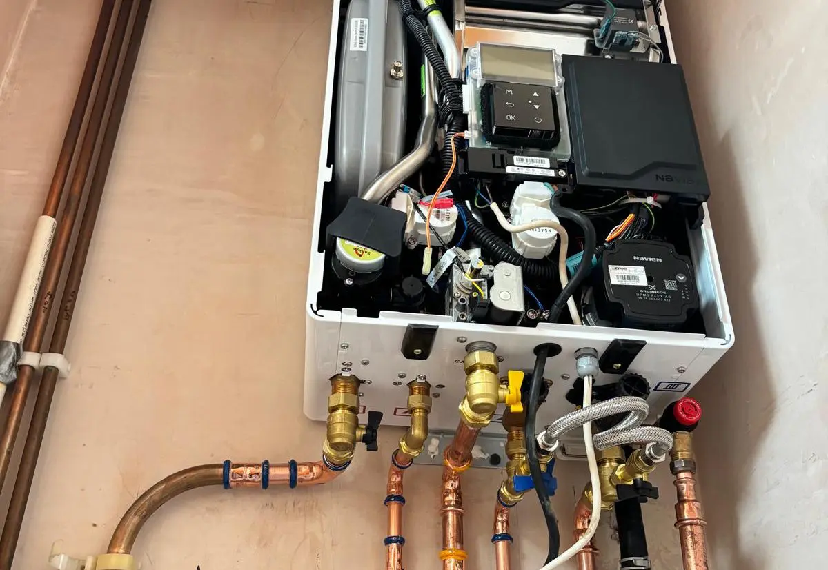 Heat365 engineer’s gas boiler installation in Sheffield with the case off, showing the internal components and new copper pipework