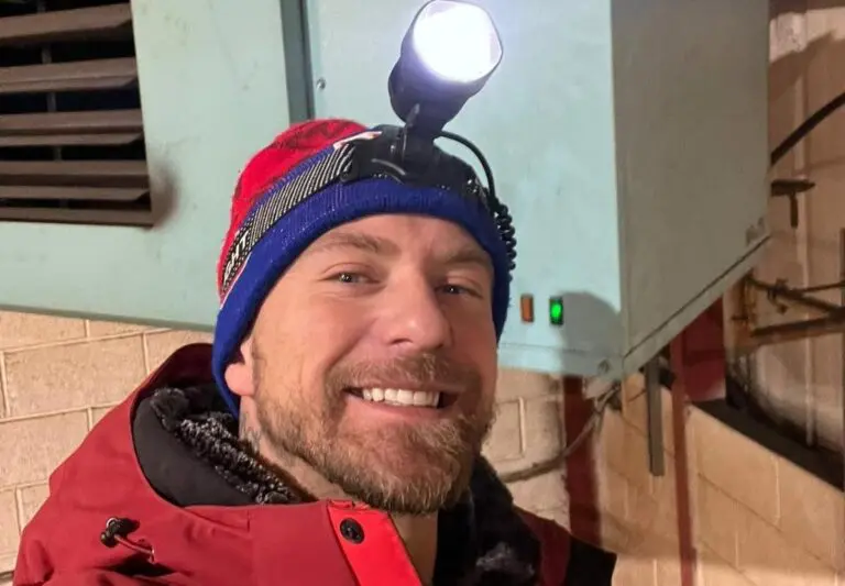 Heat365 Gas Safe registered engineer on a boiler callout in Sheffield, wearing a head torch beside a wall-mounted boiler