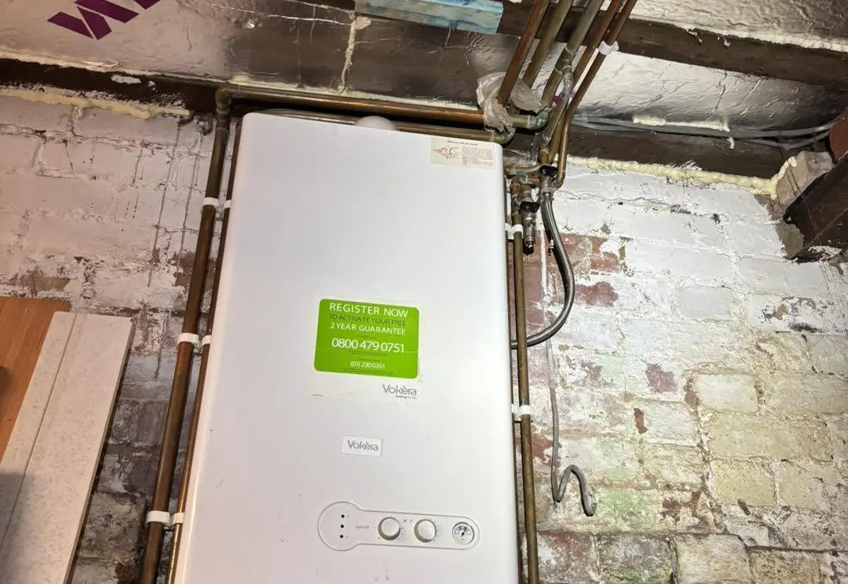 New boiler being installed by Heat365 on a stripped-back wall in a Sheffield property