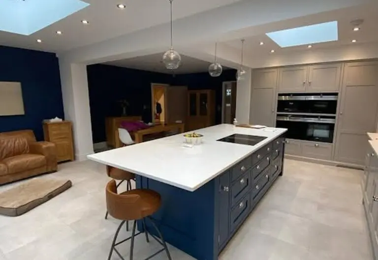 Open-plan kitchen with navy island and skylights renovated by Heat365 in Sheffield