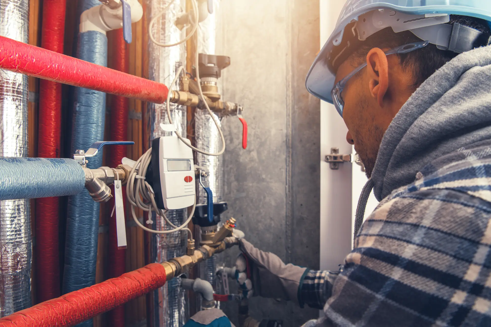 Plumber fixing pipes